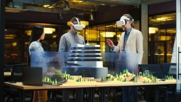 People with VR glasses looking at a building model